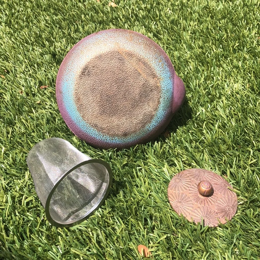 Cast iron tea pot with sunburst design